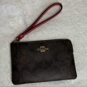 Coach, brown and burgundy signature Coach print wristlet.